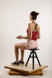 Sitting reference of whole body red shirt pink shorts black white shoes Jean